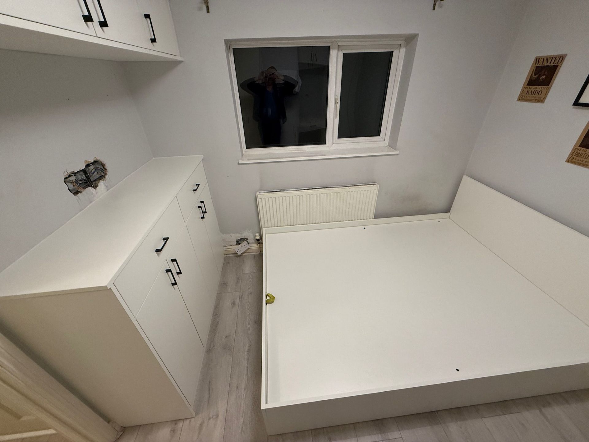 Fitted bedroom furniture in white with wardrobes, desk and overhead cupboards