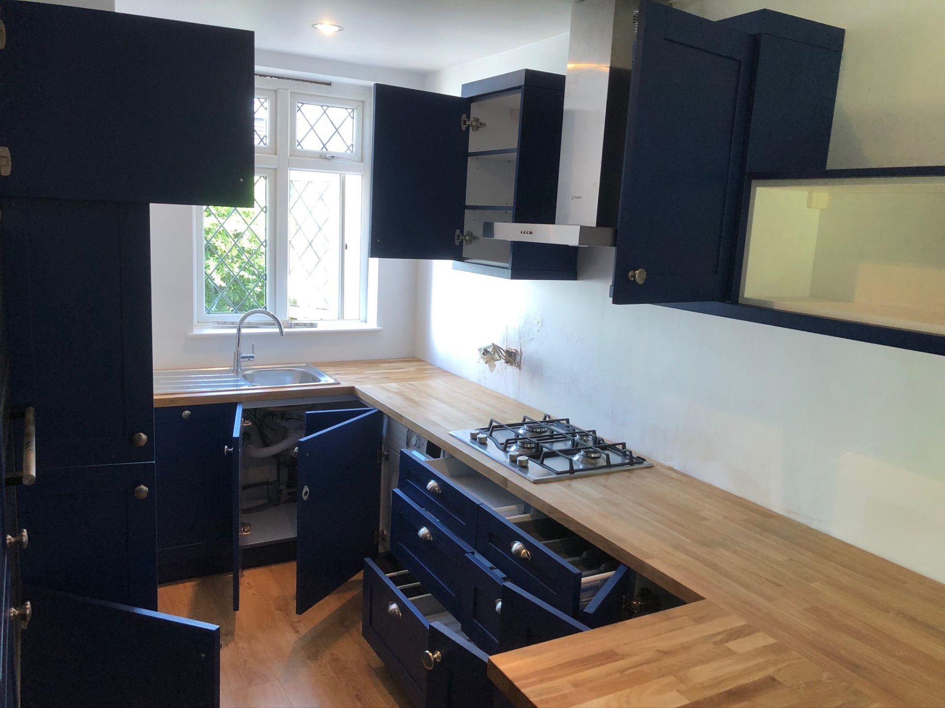 Blue kitchen cabinets with butcher block oak worktop detail