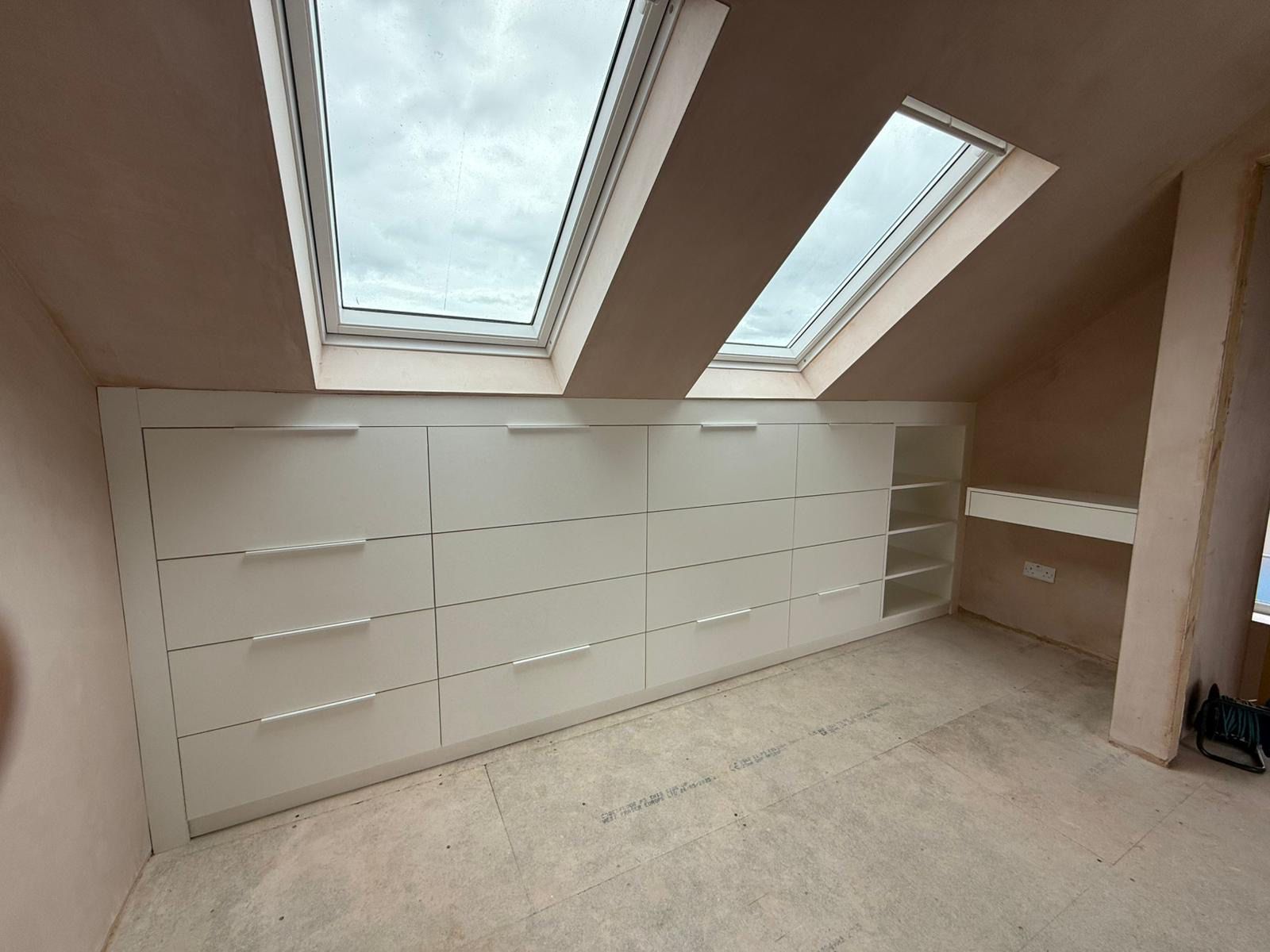Loft conversion fitted drawers built into the eaves for maximum storage