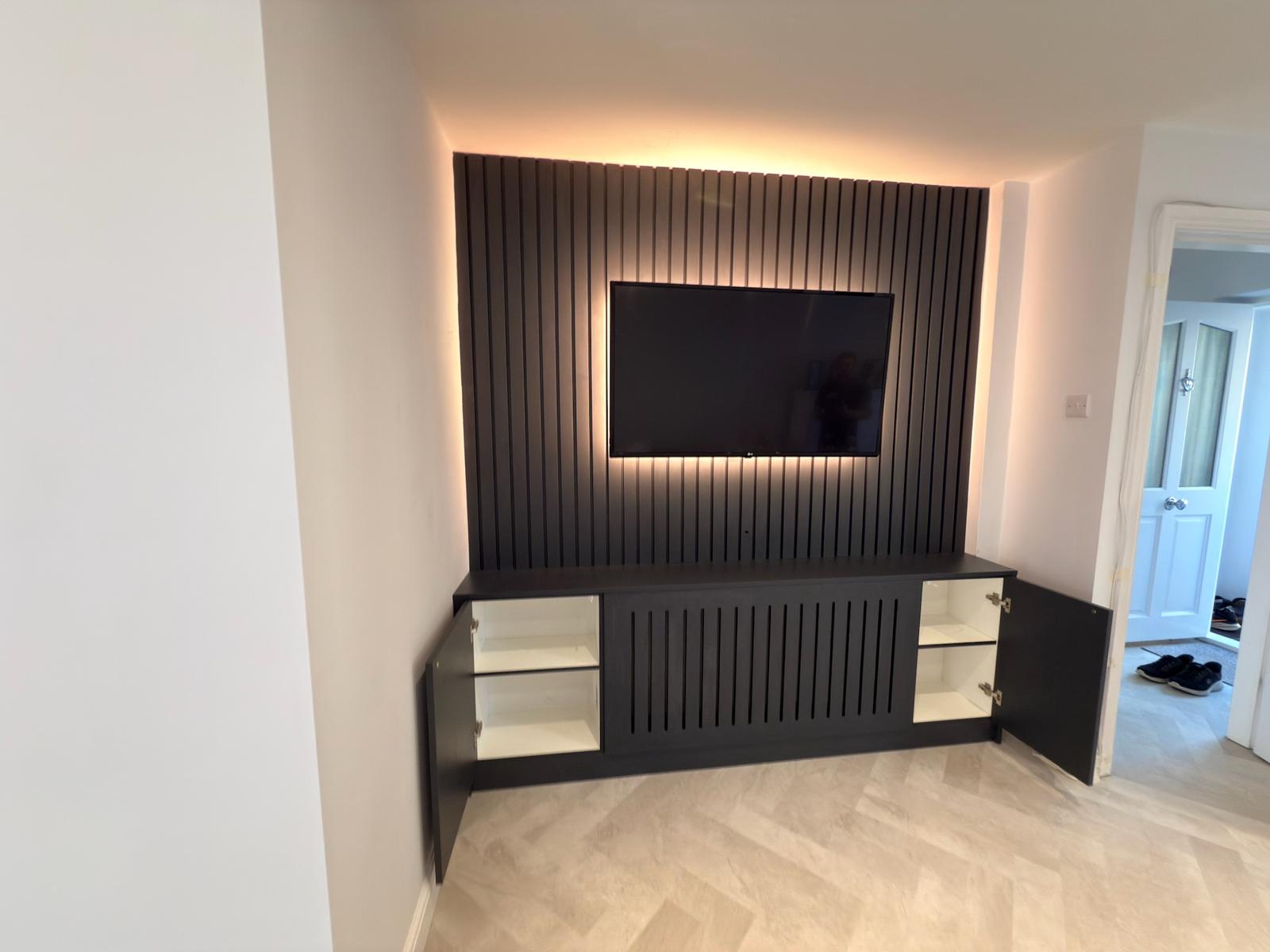 TV media wall with oak slatted panels and floating storage unit