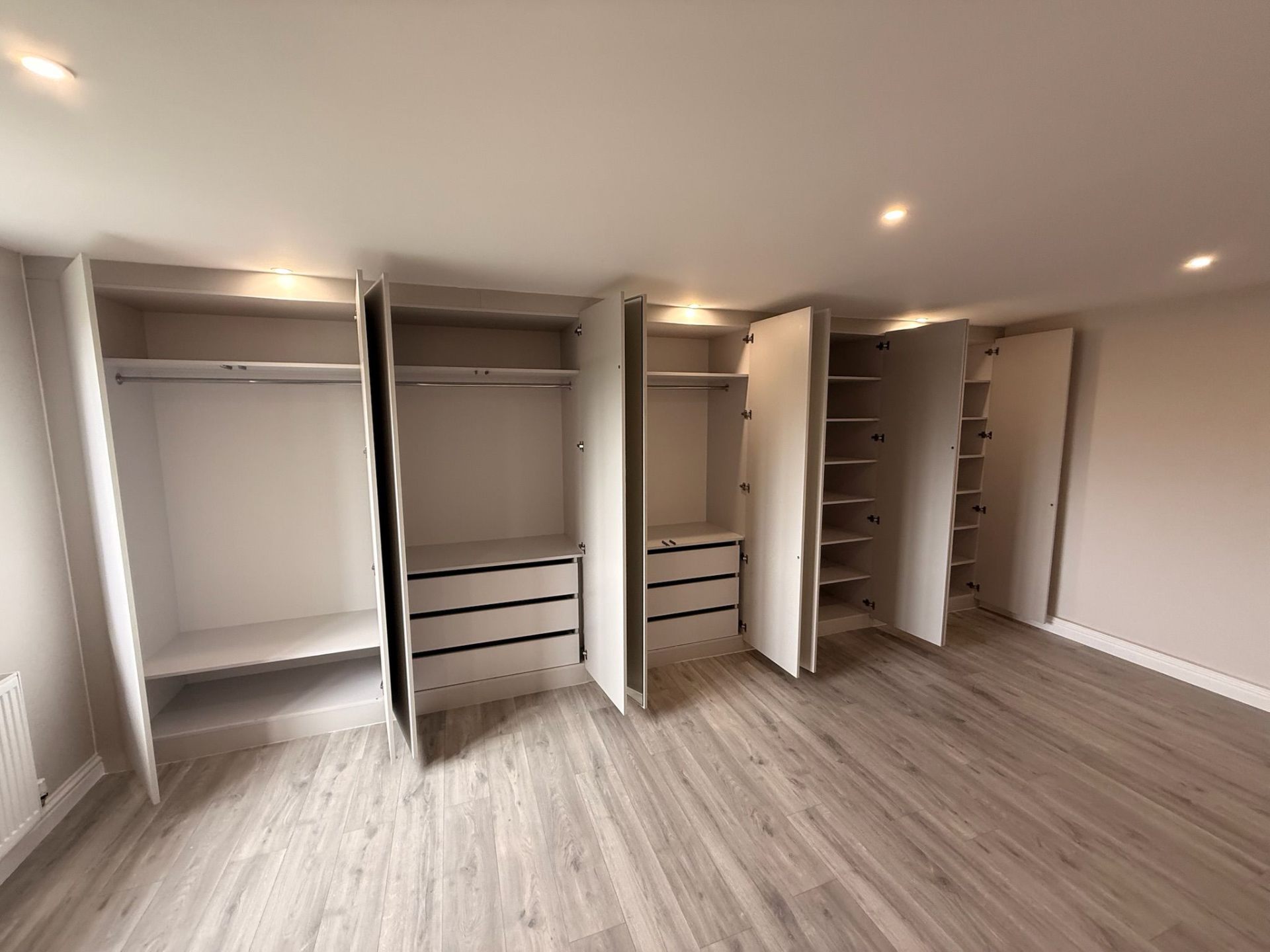 Corner fitted wardrobe open with hanging space and drawers