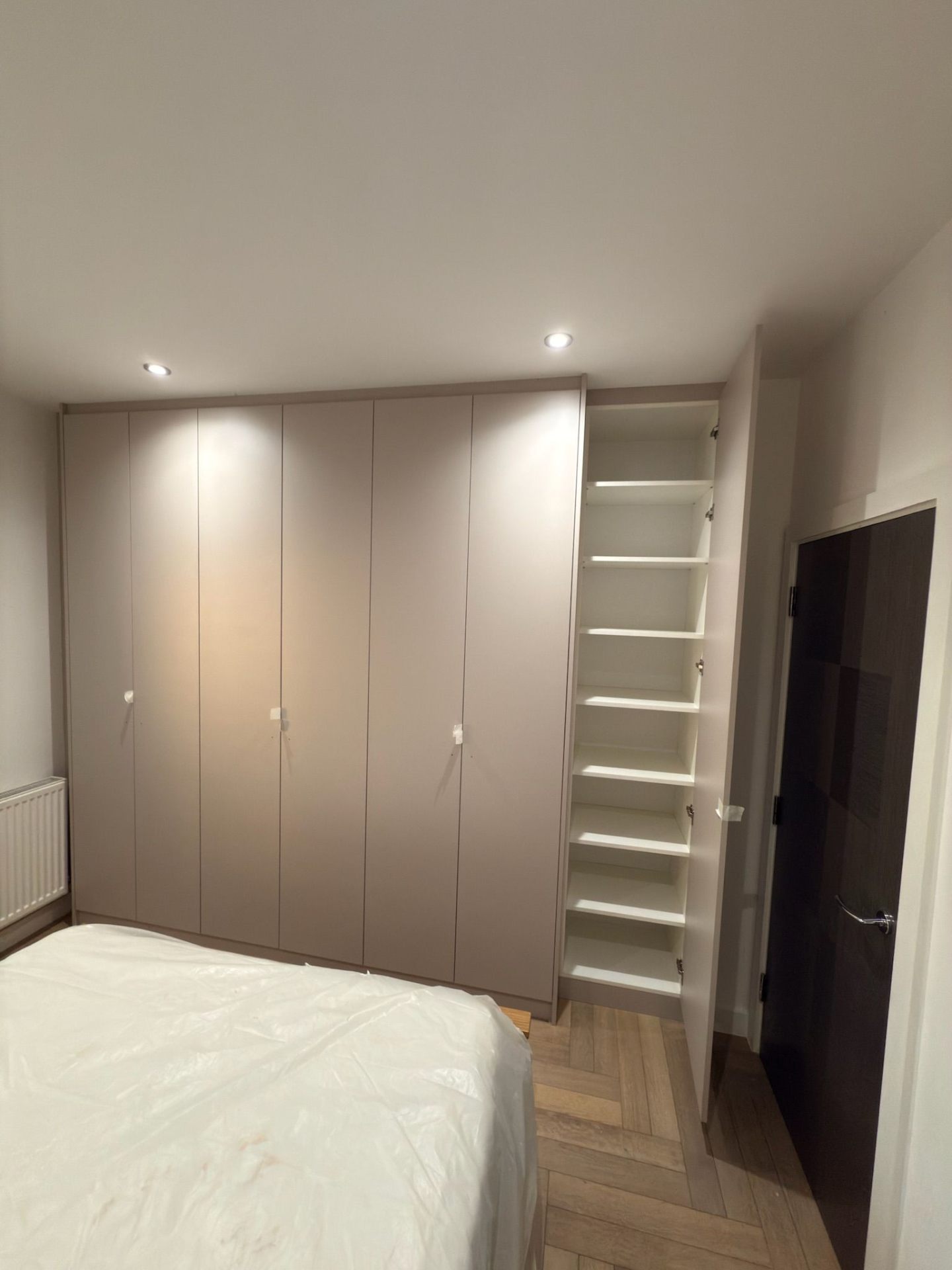 Fitted wardrobe interior in beige with adjustable shelves