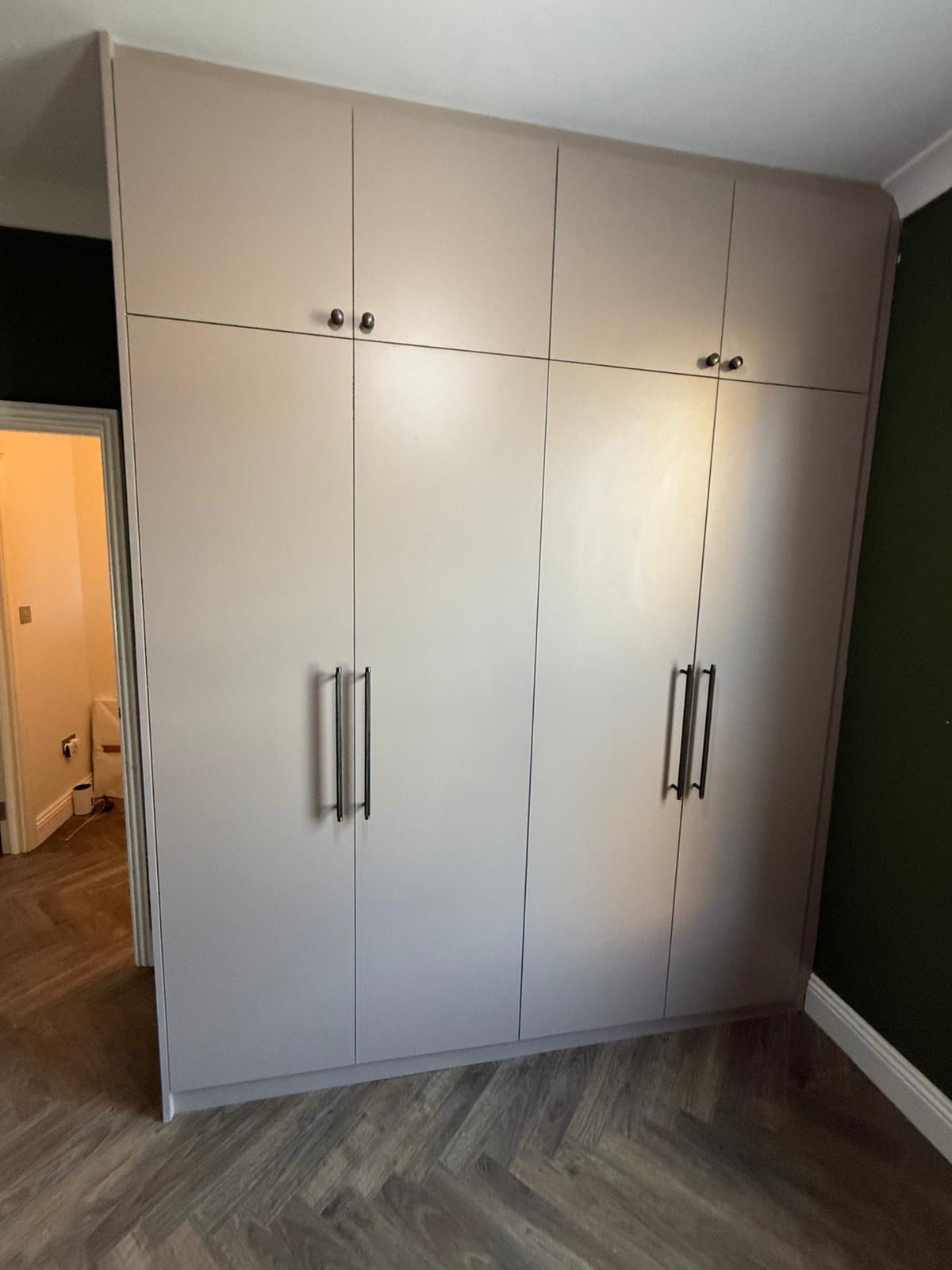 Cream fitted wardrobe with traditional panelled doors