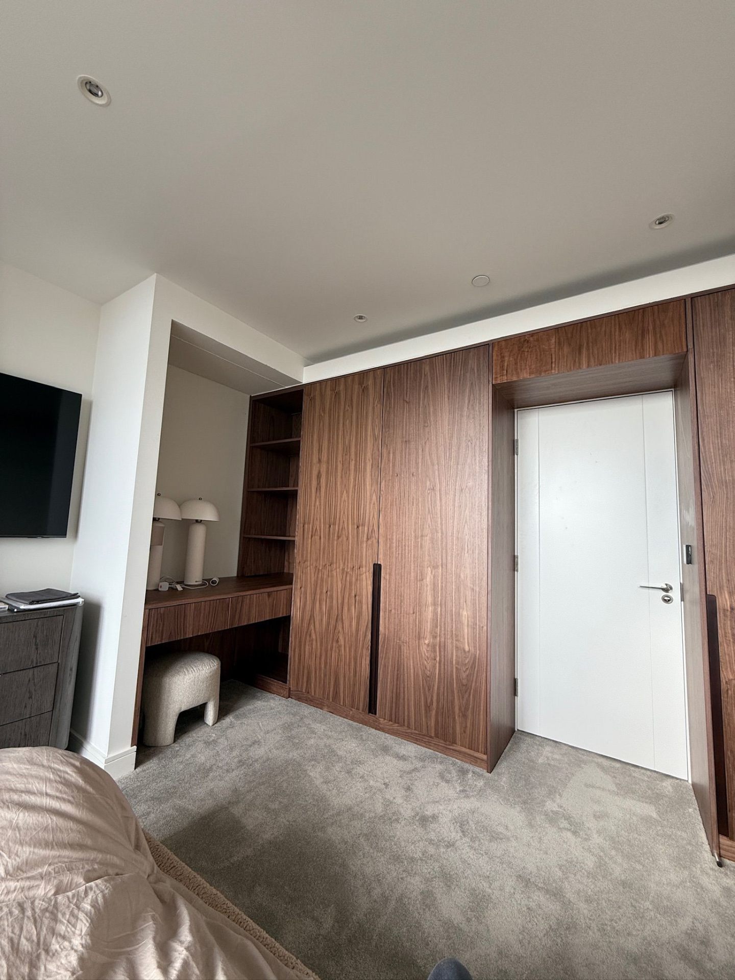 Fitted wardrobe with integrated vanity area in walnut