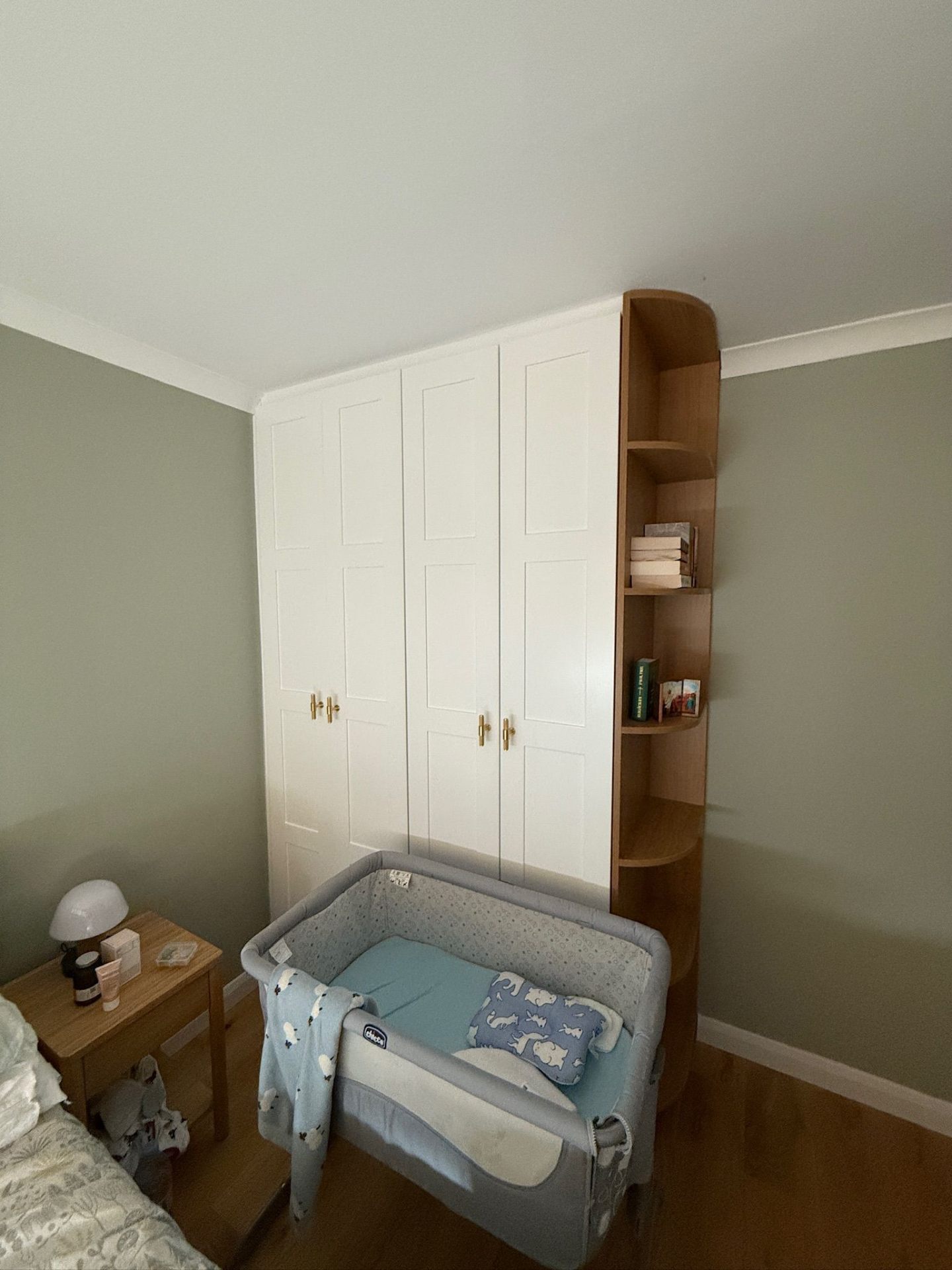 White fitted wardrobe in a nursery with soft-close doors